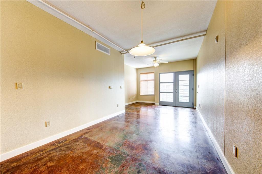 711 West 26th Street, Unit 506 Austin, TX 78705 - Photo 3 of 16 a view of an empty room with window and wooden floor