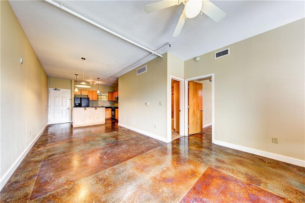 711 West 26th Street, Unit 506 Austin, TX 78705 - Photo 8 of 16 a view of a livingroom with wooden floor and a ceiling fan