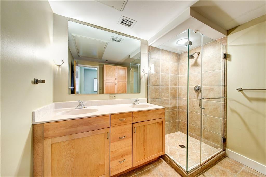 711 West 26th Street, Unit 506 Austin, TX 78705 - Photo 10 of 16 a bathroom with a shower sink and mirror