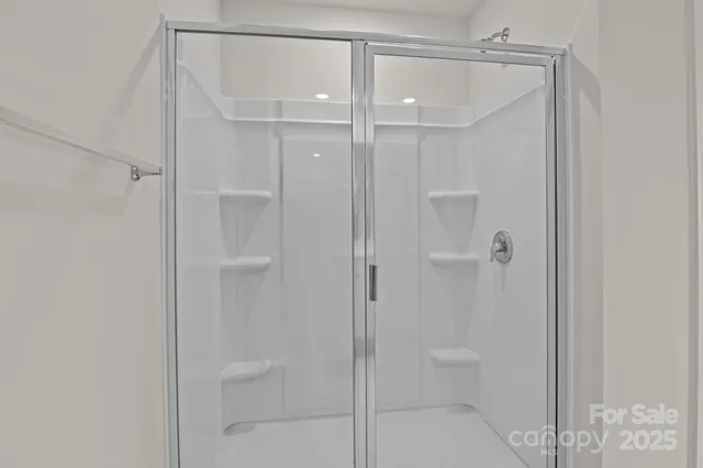 a bathroom that has a glass shower door