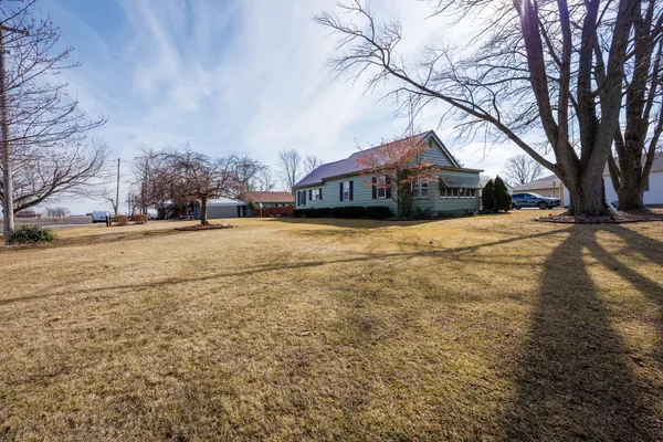 a view of a house with a yard covered in snow