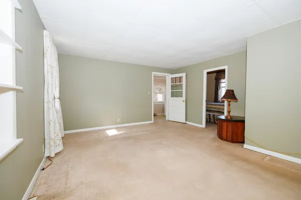 an empty room with a empty space and windows