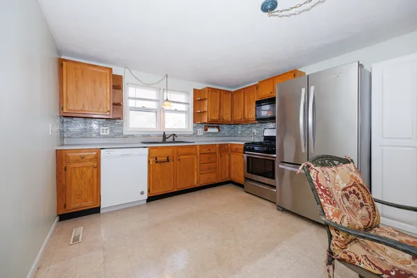 a kitchen with stainless steel appliances granite countertop a stove top oven a sink and dishwasher