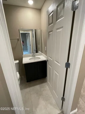 a bathroom with a sink a mirror and vanity