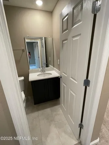 a bathroom with a sink a mirror and vanity