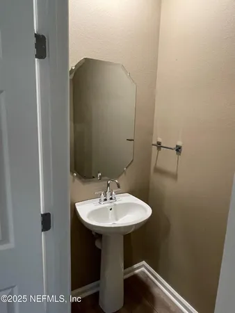 a bathroom with a sink and a mirror