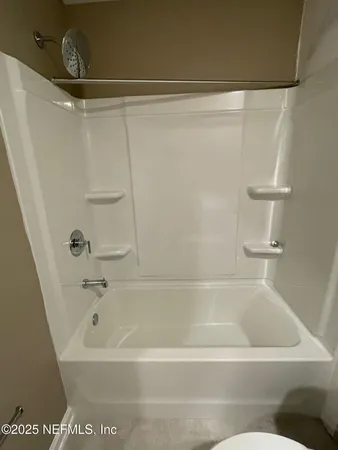a bathroom with a shower and a bath tub