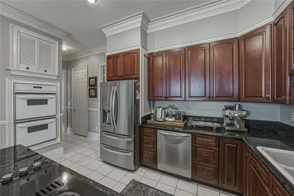 a spacious bedroom with a bed and a chandelier