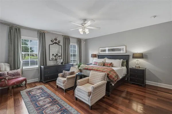 a view of a livingroom with wooden floor and a ceiling fan