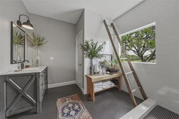 a living room with furniture and a floor to ceiling window