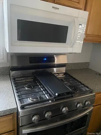 a stove top oven sitting inside of a kitchen