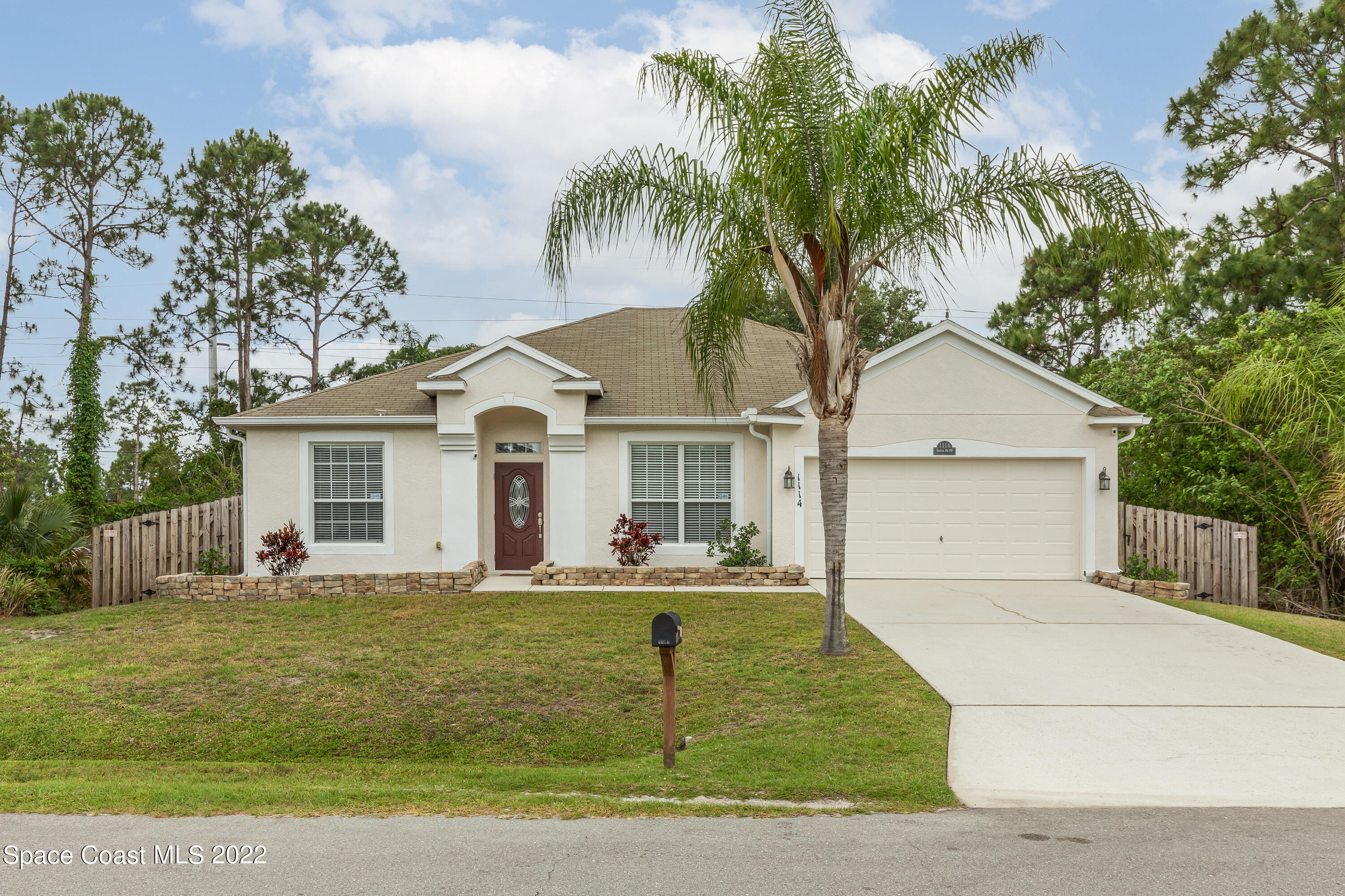 1114 Sexton Road Southwest Palm Bay, FL 32908 - Photo 1 of 19 a front view of a house with a yard