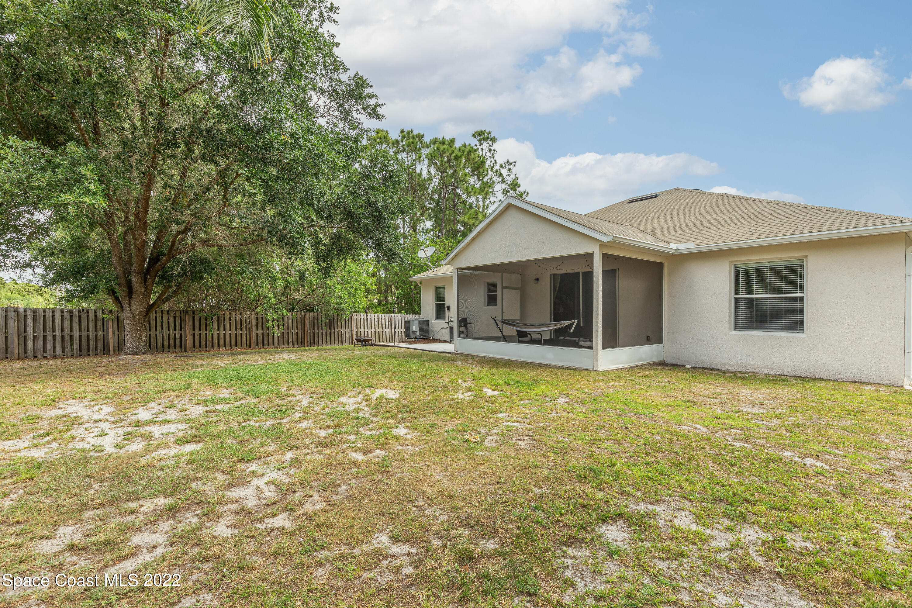 1114 Sexton Road Southwest Palm Bay, FL 32908 - Photo 17 of 19 a view of a house with a swimming pool and a yard