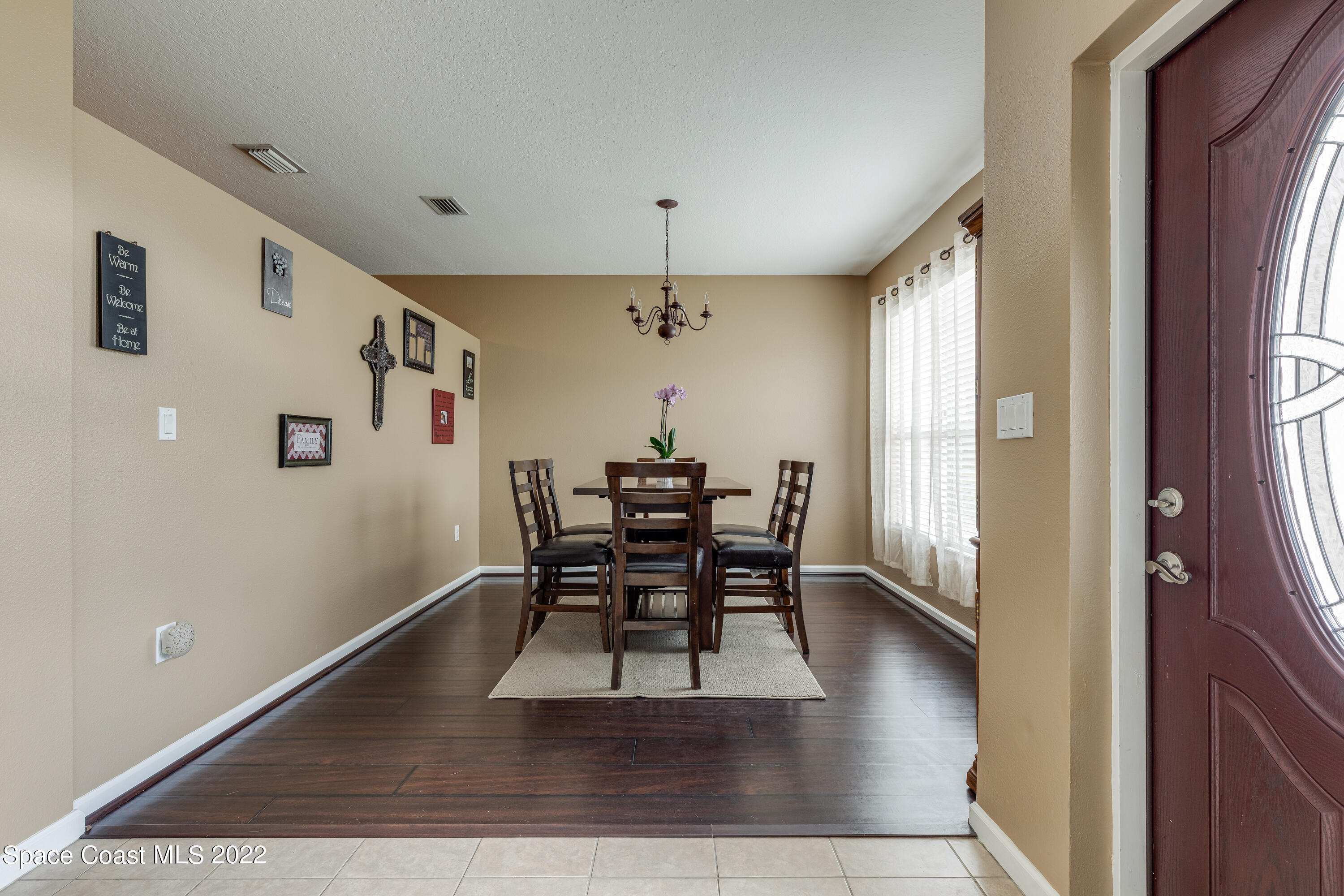 1114 Sexton Road Southwest Palm Bay, FL 32908 - Photo 4 of 19 a dining room with furniture window and wooden floor