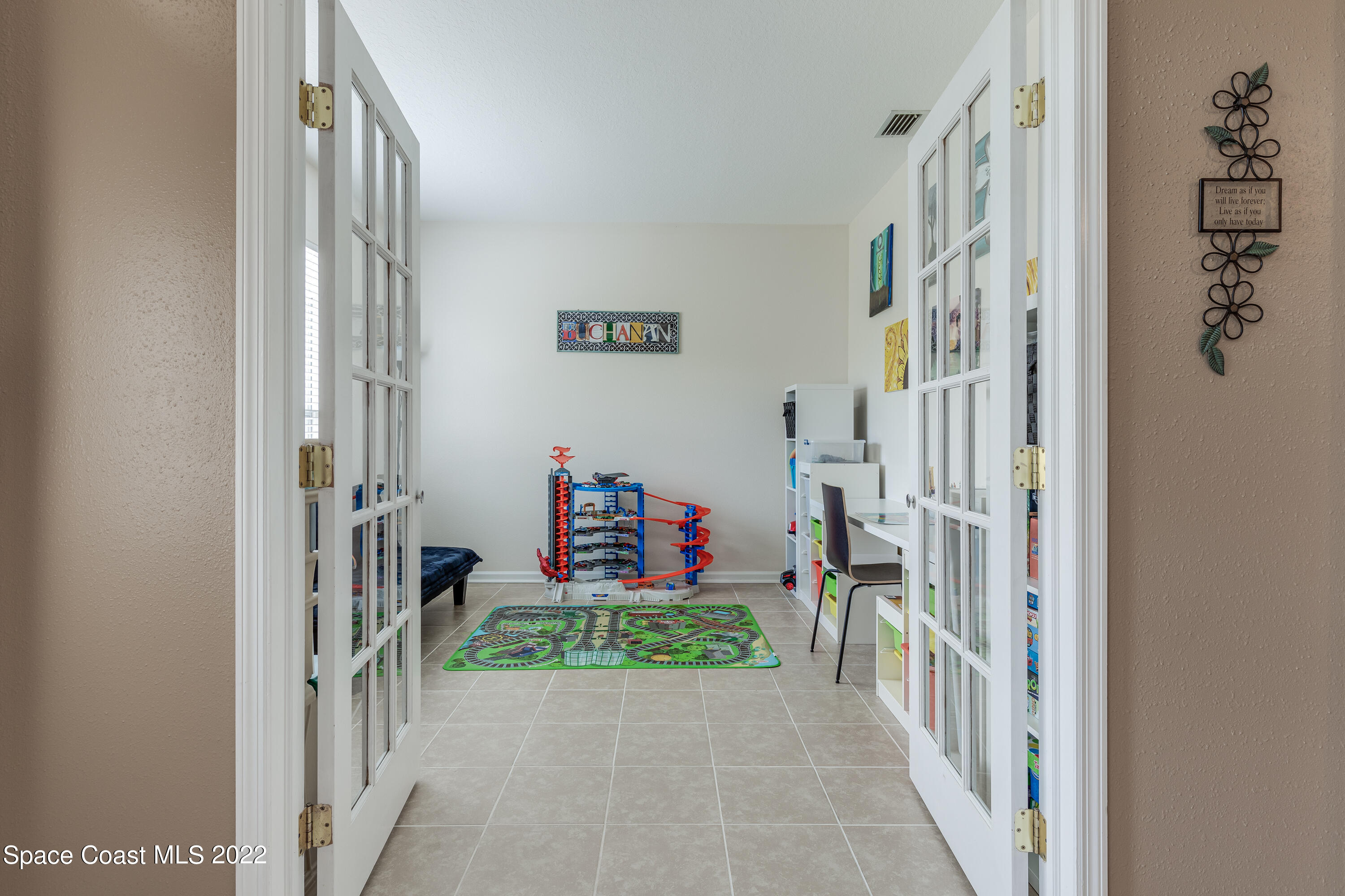 1114 Sexton Road Southwest Palm Bay, FL 32908 - Photo 5 of 19 a view of a hallway with paintings on the walls