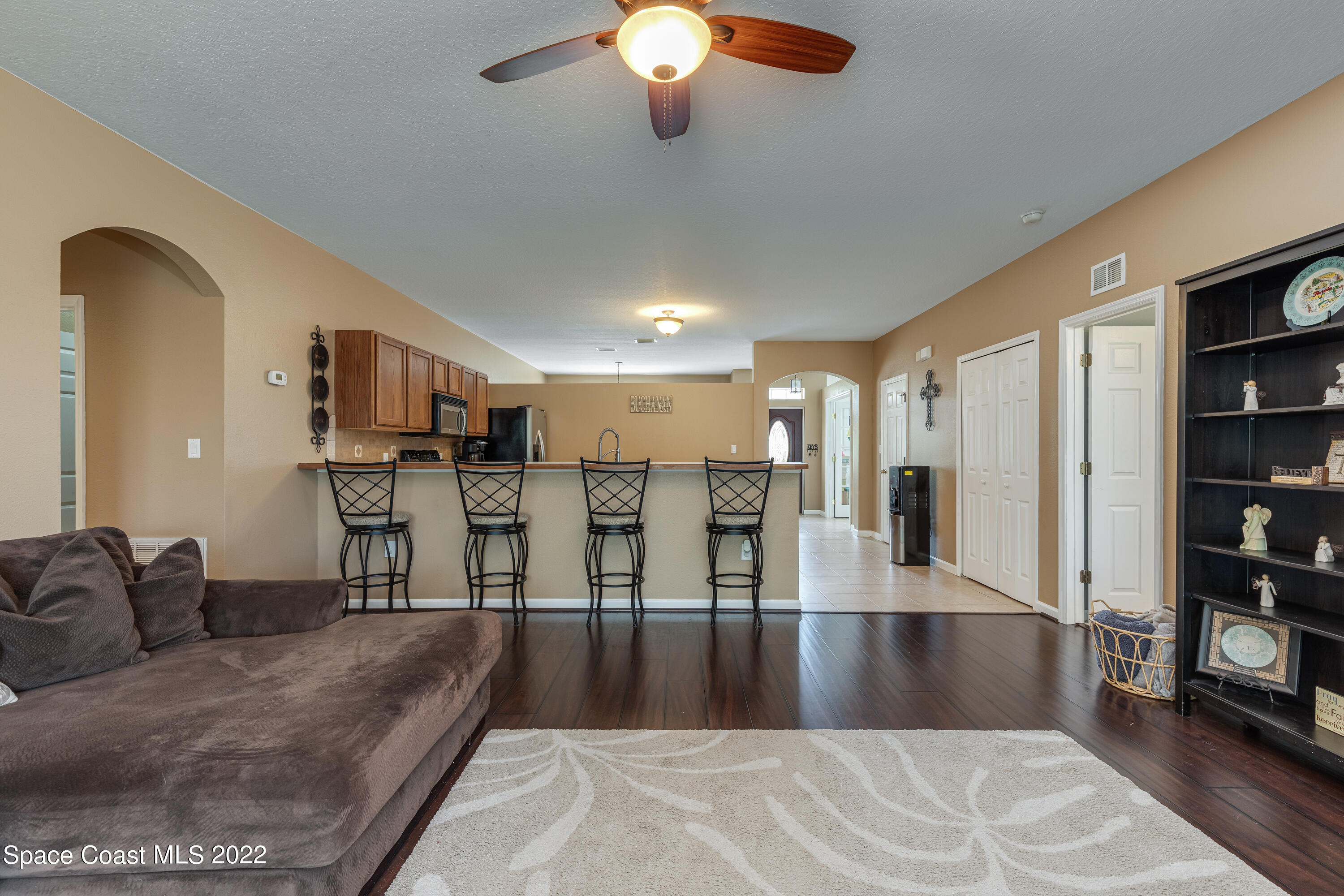 1114 Sexton Road Southwest Palm Bay, FL 32908 - Photo 8 of 19 a view of a living room a kitchen island and a window