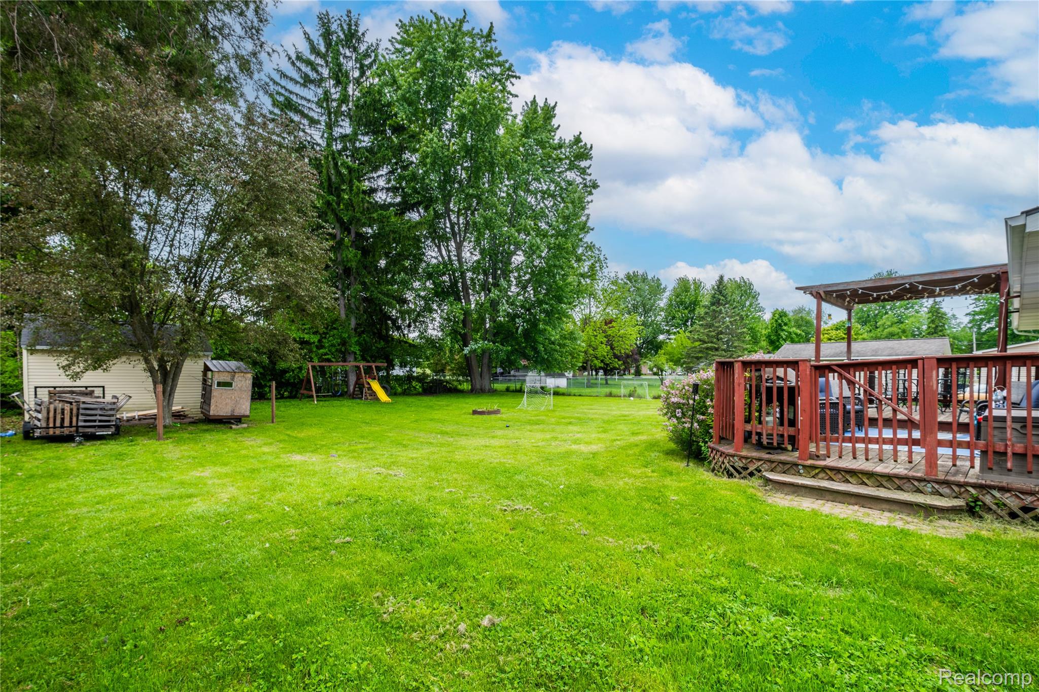 7800 Maple Street Birch Run, MI 48415 - Photo 22 of 29 Expansive green lawn with mature trees and a dedicated shed