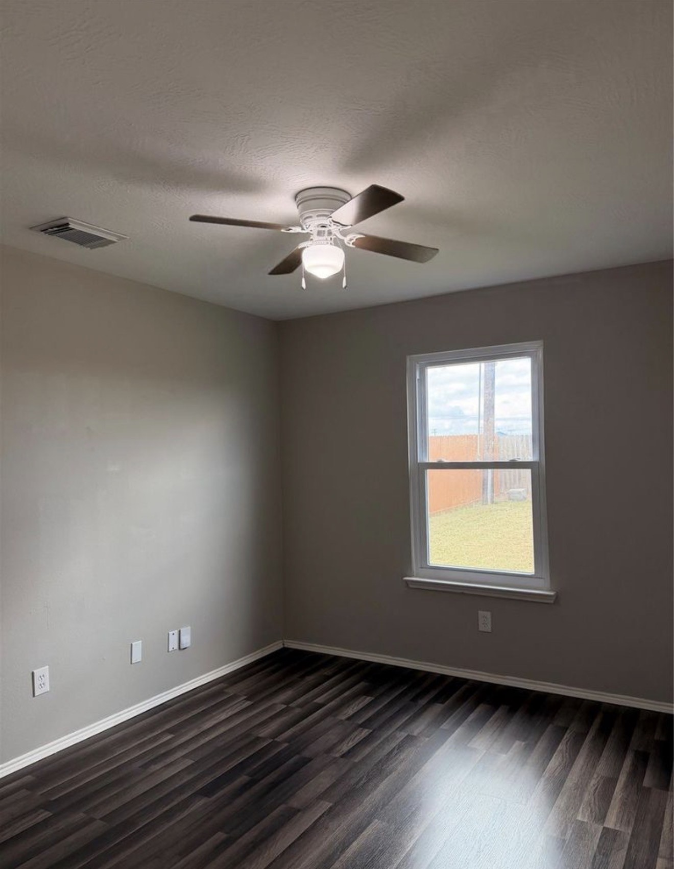 4707 East Parma Drive Rosenberg, TX 77471 - Photo 12 of 22 an empty room with a window and a ceiling fan
