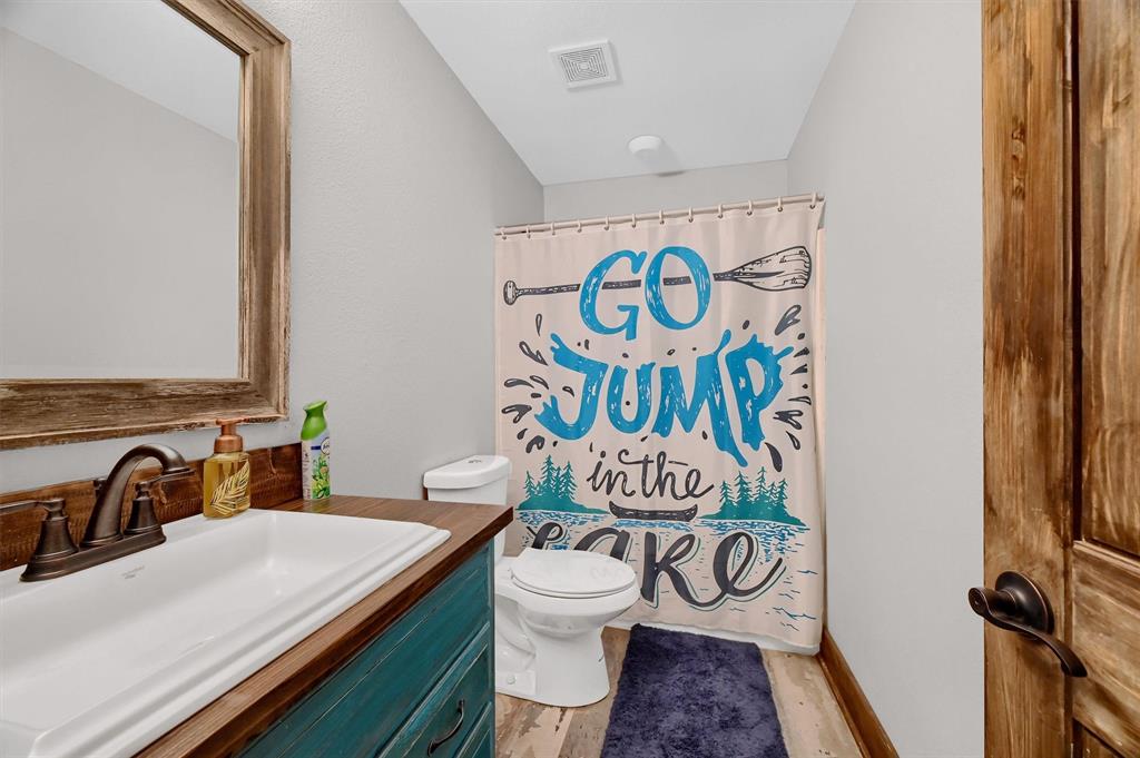 2003 Flowing Wells Road Pottsboro, TX 75076 - Photo 31 of 39 Bathroom with vanity, toilet, and hardwood / wood-style floors