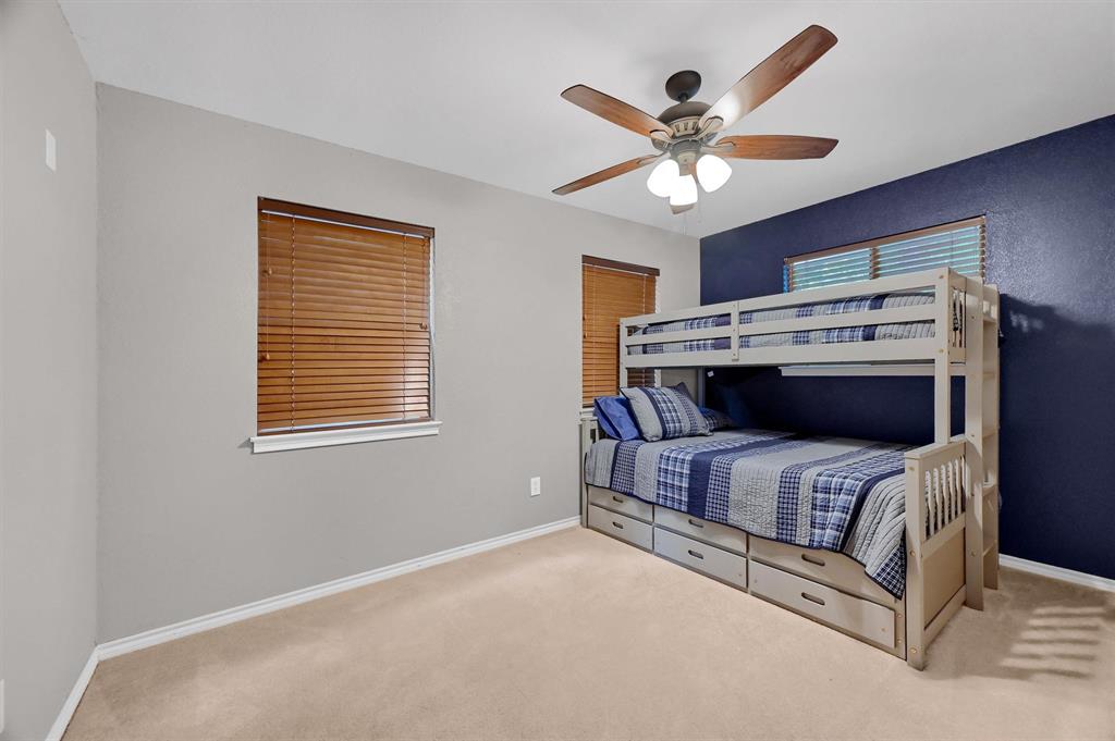 2003 Flowing Wells Road Pottsboro, TX 75076 - Photo 32 of 39 Bedroom with light colored carpet and ceiling fan