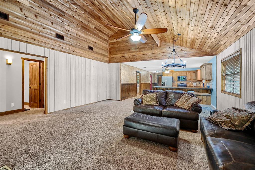2003 Flowing Wells Road Pottsboro, TX 75076 - Photo 10 of 39 Living room featuring wooden ceiling, light colored carpet, high vaulted ceiling, and ceiling fan