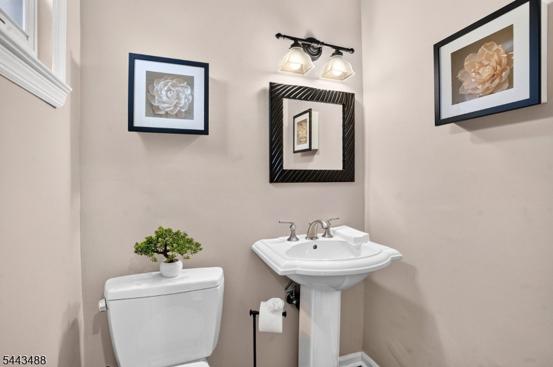 151 East Prospect Street Clark, NJ 07066 - Photo 24 of 31 a bathroom with a toilet sink and mirror