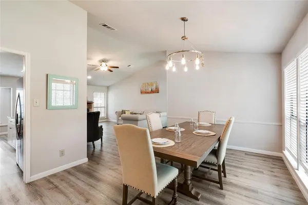a view of a dining room with furniture and wooden floor