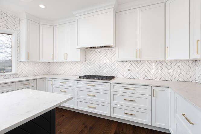1530 White Eagle Drive Naperville, IL 60564 - Photo 14 of 43 a kitchen with granite countertop white cabinets and white appliances