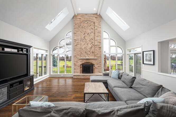 1530 White Eagle Drive Naperville, IL 60564 - Photo 16 of 43 a living room with furniture a fireplace and a flat screen tv