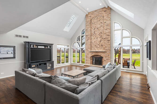 1530 White Eagle Drive Naperville, IL 60564 - Photo 17 of 43 a living room with fireplace furniture and a flat screen tv