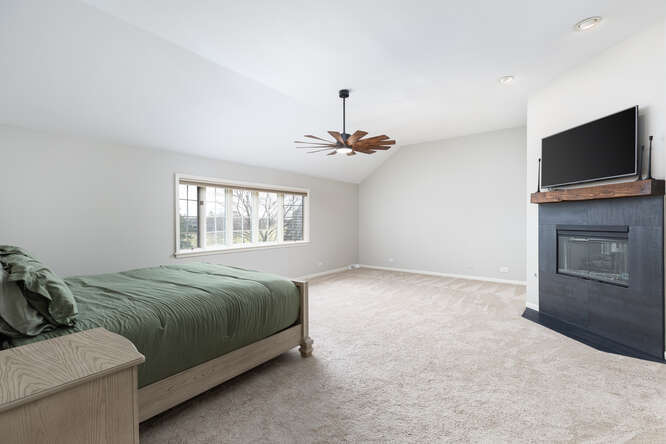 1530 White Eagle Drive Naperville, IL 60564 - Photo 22 of 43 a spacious bedroom with a bed and a flat screen tv
