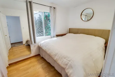 a bedroom with bed and window