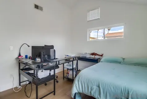 a bedroom with a bed and a desk