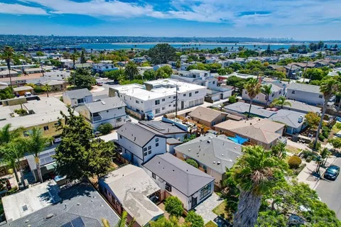 an aerial view of residential building and ocean