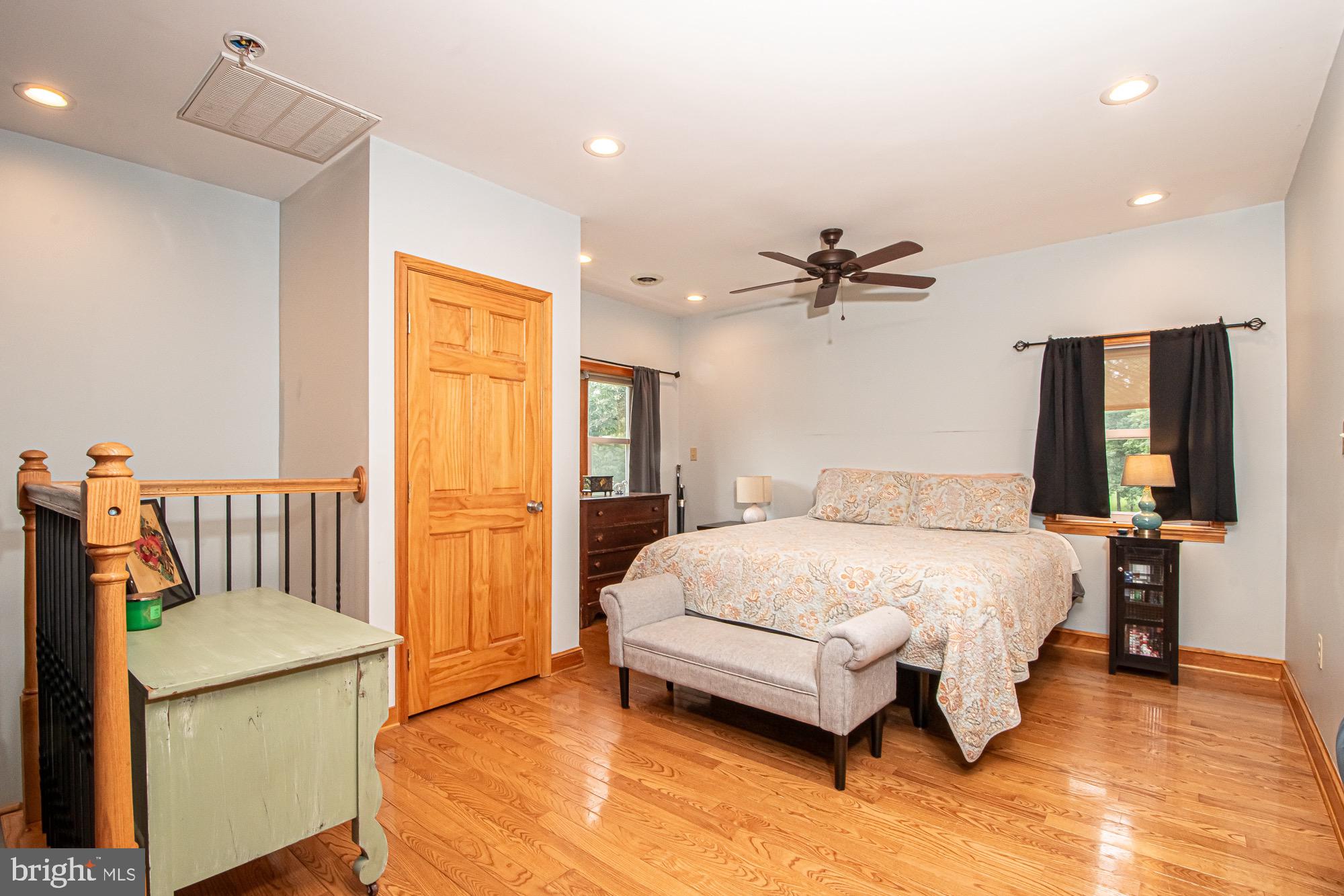 2180 Strasburg Road Front Royal, VA 22630 - Photo 24 of 90 a spacious bedroom with a bed and a chandelier