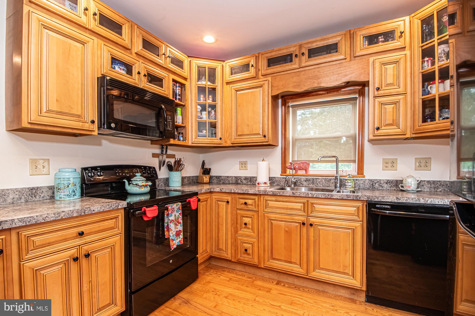 2180 Strasburg Road Front Royal, VA 22630 - Photo 33 of 90 a kitchen with stainless steel appliances granite countertop a stove sink microwave and cabinets