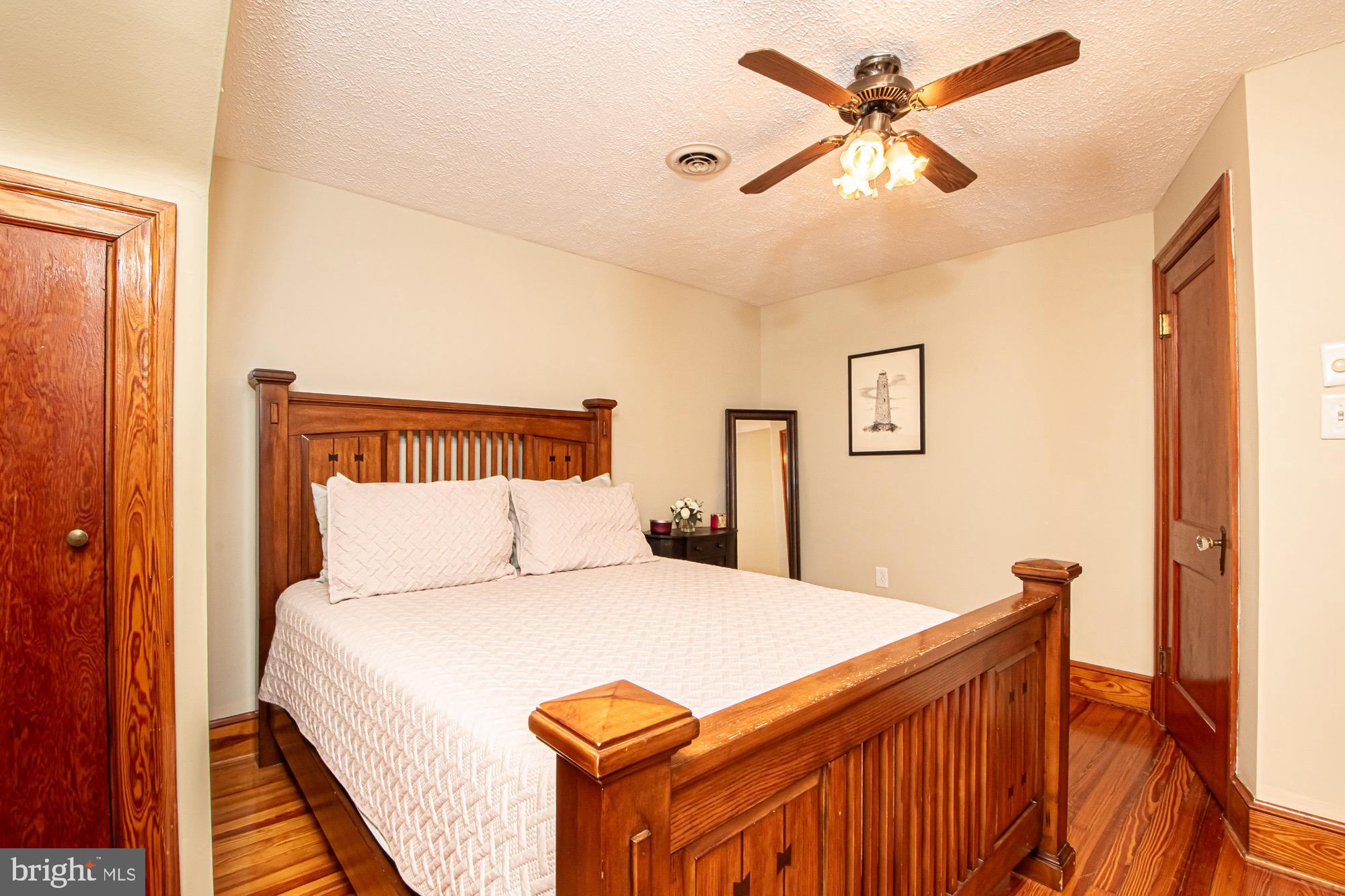 2180 Strasburg Road Front Royal, VA 22630 - Photo 64 of 90 a bedroom with a bed and a chandelier