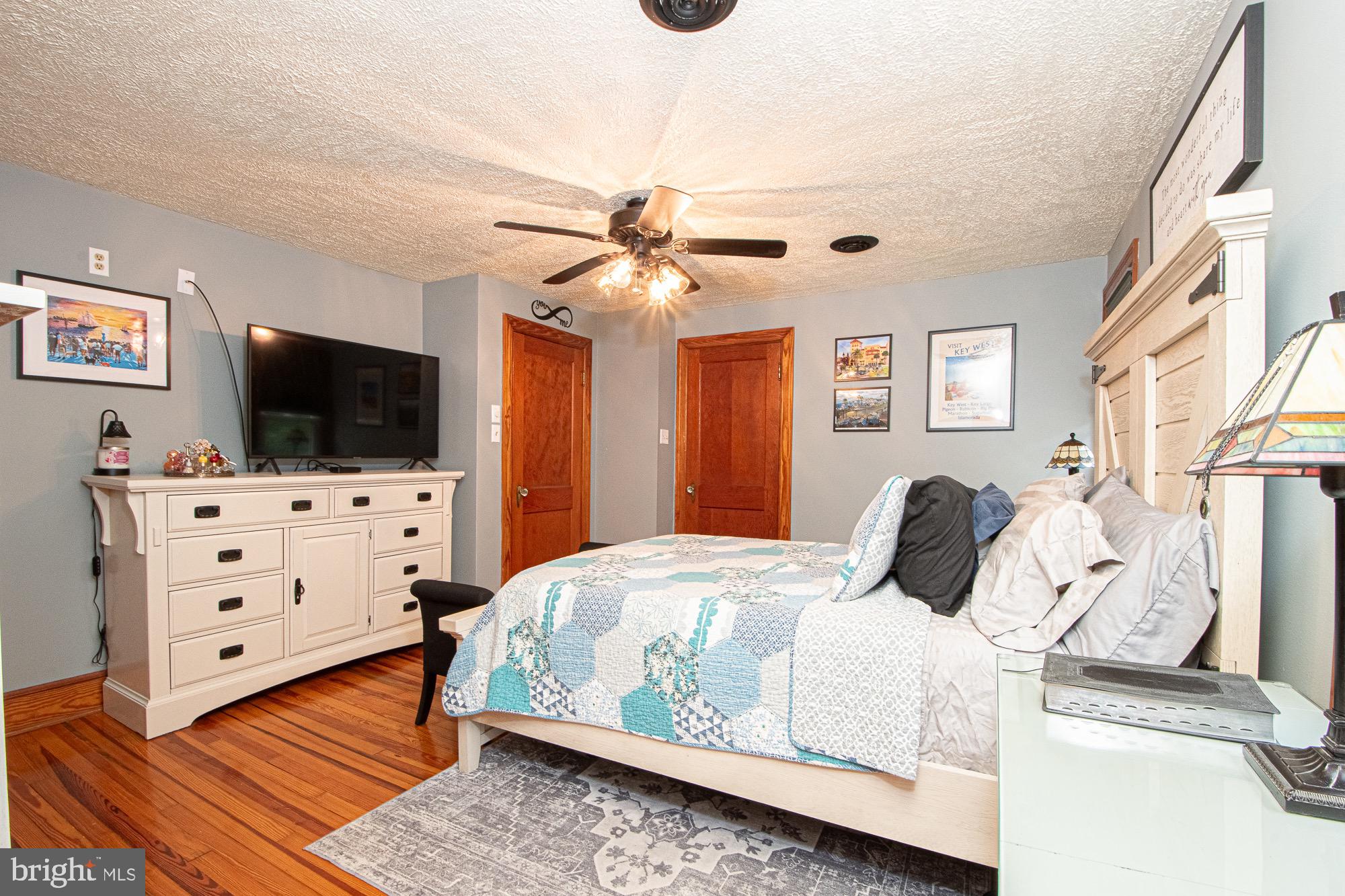 2180 Strasburg Road Front Royal, VA 22630 - Photo 69 of 90 a bedroom with a bed and a flat tv screen on dresser