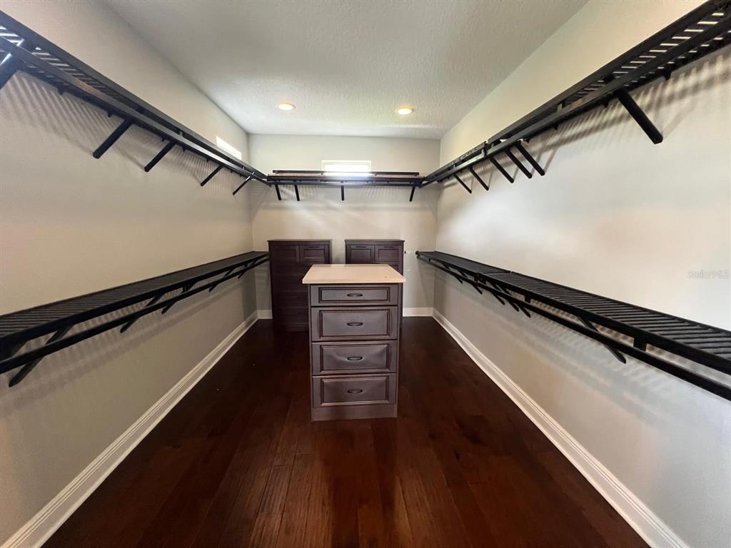 12927 Canopy Woods Way Winter Garden, FL 34787 - Photo 29 of 41 a view of walk in closet with clothes