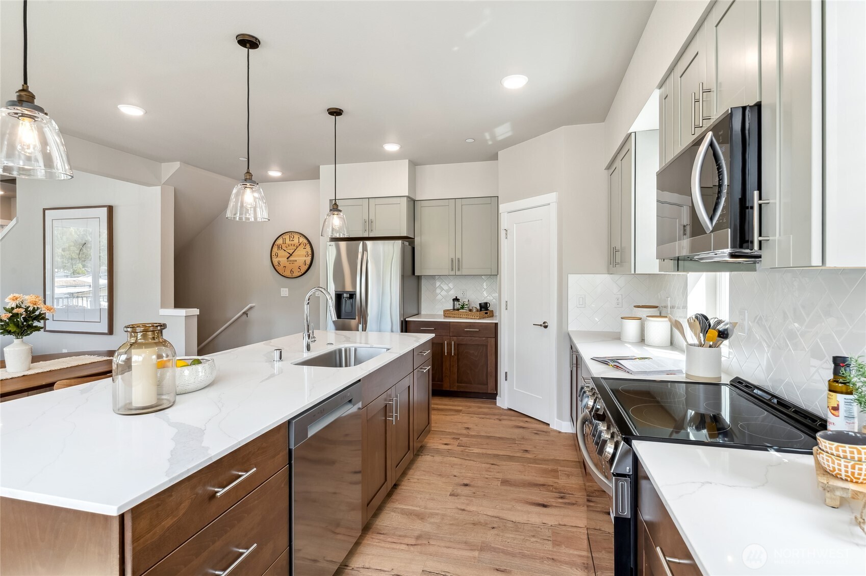 1322 194th Street Southeast, Unit D6 Bothell, WA 98012 - Photo 8 of 18 a kitchen with a sink a stove and chairs