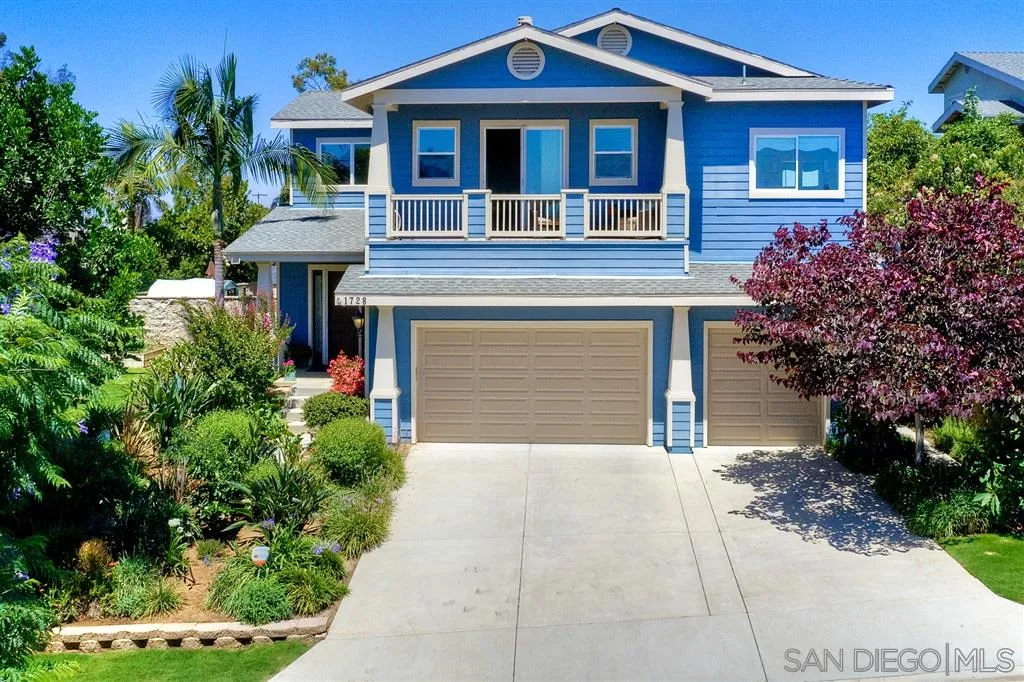 1728 Yucca Road Oceanside, CA 92054 - Photo 1 of 25 a front view of a house with a yard and garage