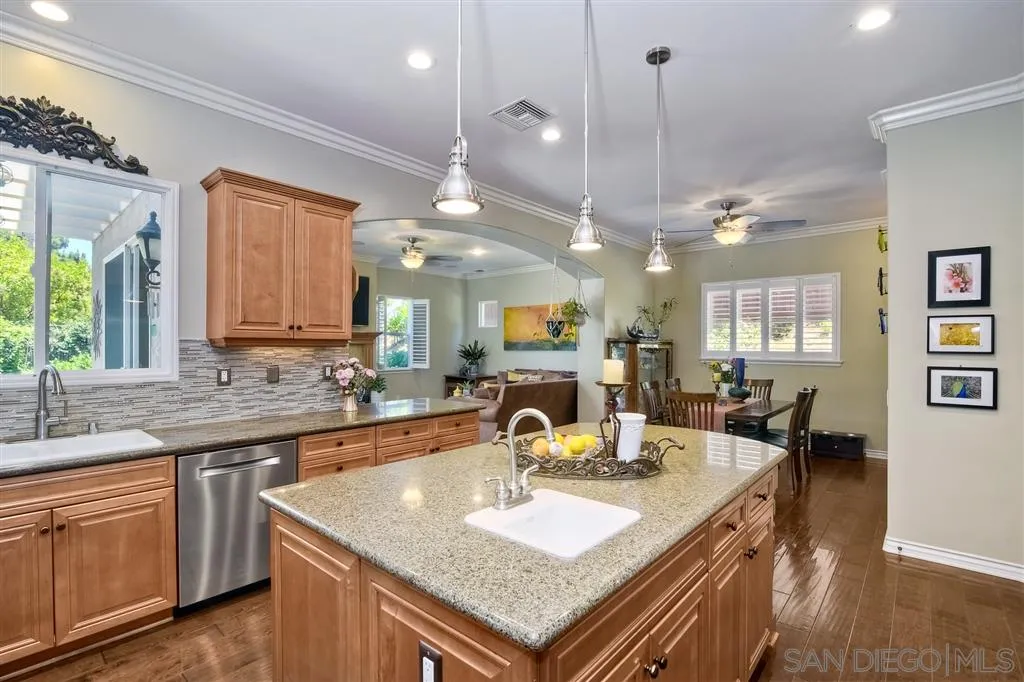 1728 Yucca Road Oceanside, CA 92054 - Photo 12 of 25 a kitchen with granite countertop a sink a counter top space and living room view