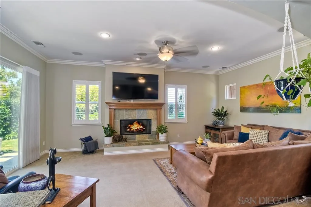 1728 Yucca Road Oceanside, CA 92054 - Photo 14 of 25 a living room with furniture a flat screen tv and a fireplace