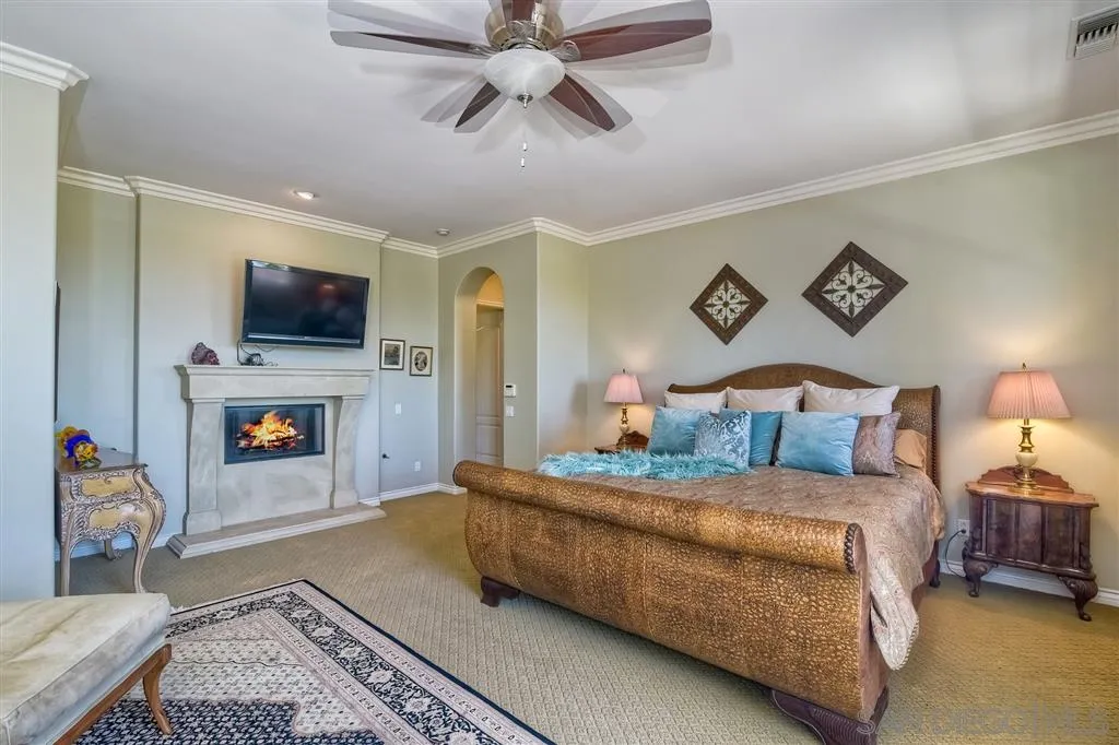 1728 Yucca Road Oceanside, CA 92054 - Photo 16 of 25 a bedroom with a bed and a fireplace