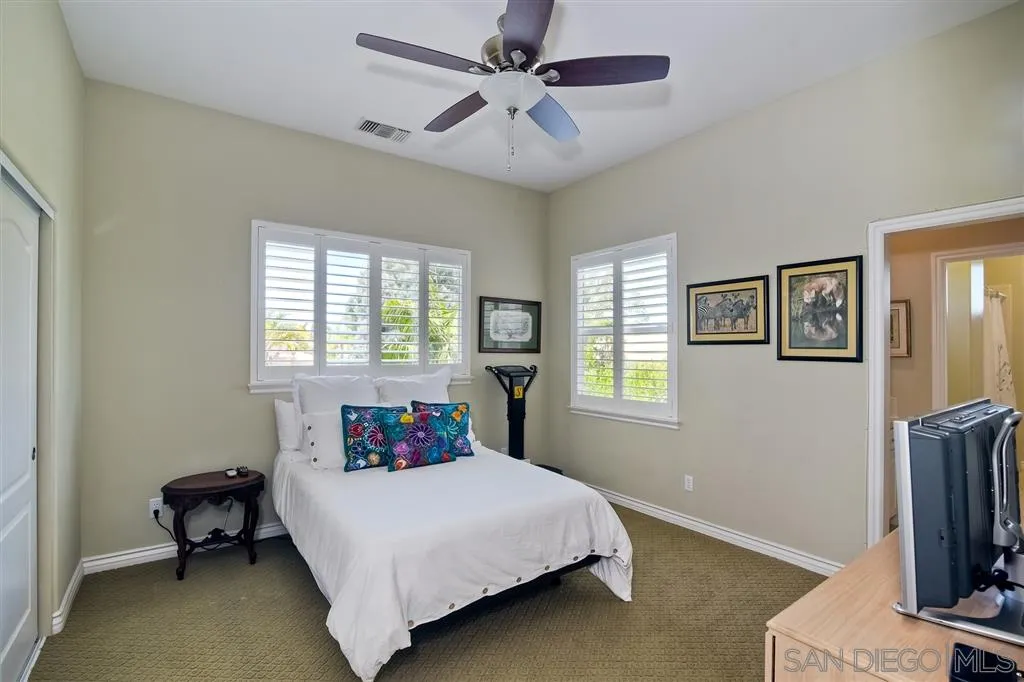 1728 Yucca Road Oceanside, CA 92054 - Photo 18 of 25 a bedroom with a bed tv and a window