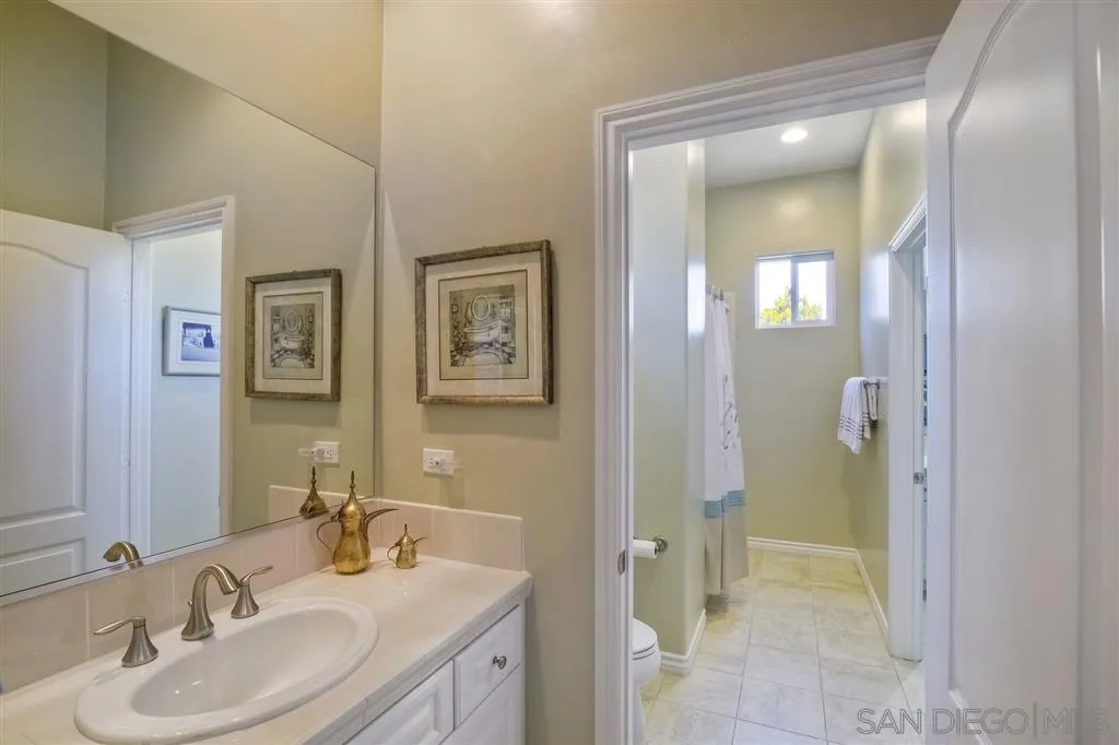 1728 Yucca Road Oceanside, CA 92054 - Photo 19 of 25 a bathroom with a sink and a mirror