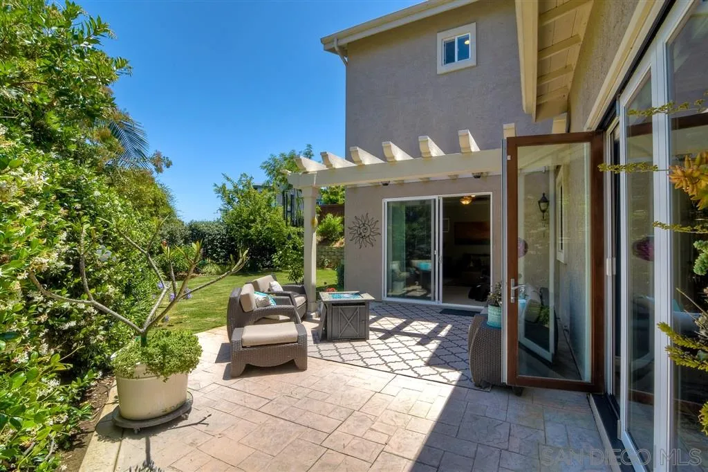 1728 Yucca Road Oceanside, CA 92054 - Photo 23 of 25 a front view of a house with outdoor seating and a garden