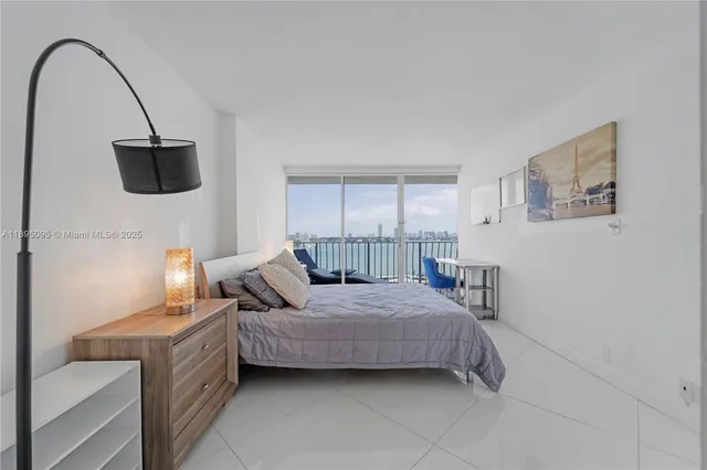 a bedroom with a bed a couch and dresser