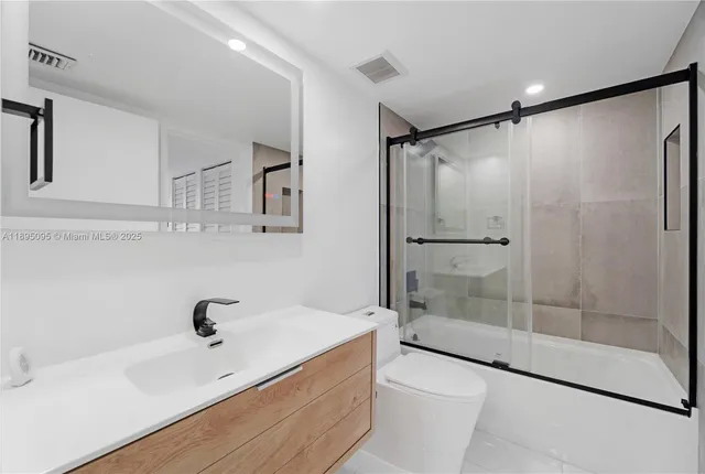 a bathroom with a shower and a sink