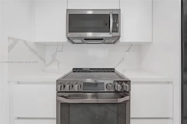 a stove top oven sitting inside of a kitchen